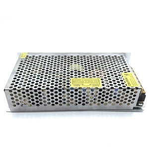 Switching Power Supply SMPS 12V 10A - a rectangular silver metal unit with a perforated cover and a yellow voltage selection warning label.