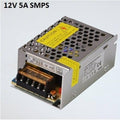 Switching Power Supply SMPS 12V 5A - a metallic, rectangular power supply unit with a perforated top cover, screw terminals, and a voltage adjustment knob.