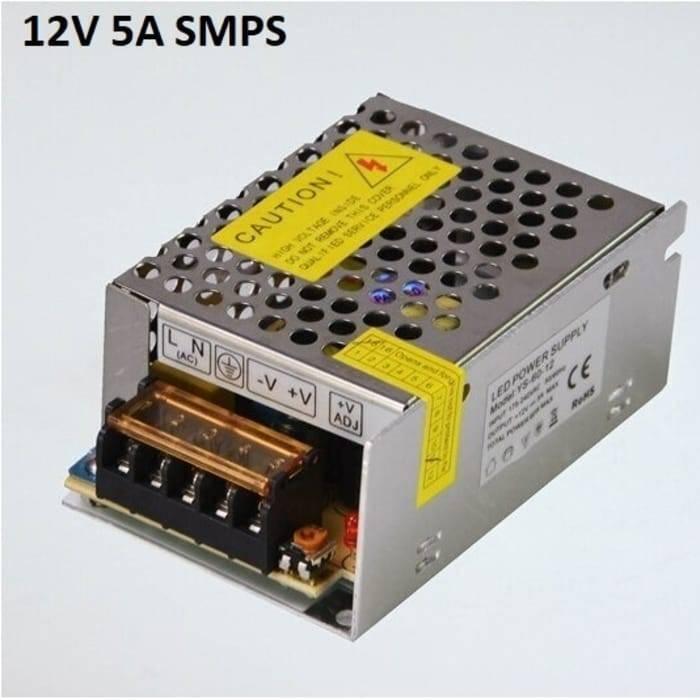 Switching Power Supply SMPS 12V 5A - a metallic, rectangular power supply unit with a perforated top cover, screw terminals, and a voltage adjustment knob.