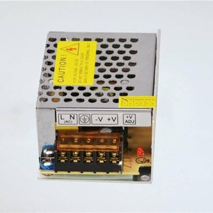 Switching Power Supply SMPS 12V 5A - a silver metal casing with a yellow caution label, a terminal block for AC/DC connections, and a red LED.