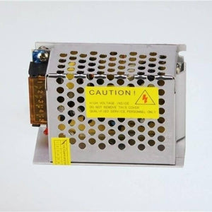 Switching Power Supply SMPS 12V 5A - shown as a silver metal-cased unit with a perforated cover, a yellow caution label, and a side terminal block.