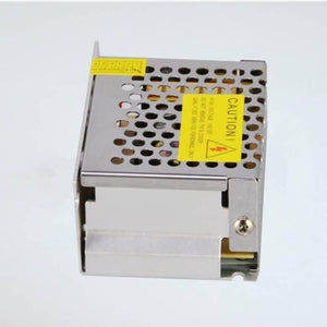 Switching Power Supply SMPS 12V 5A - shown as a metallic, perforated rectangular unit with a yellow caution label and a numbered terminal block strip.