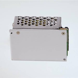 Switching Power Supply SMPS 12V 5A - shown as a silver-coloured metal rectangular unit with a perforated top cover and a side-mounted circuit board.