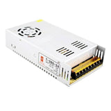 Switching Power Supply SMPS 24V 15A - shown as a white metal rectangular unit with a cooling fan, ventilation slots, and a terminal block on one side.