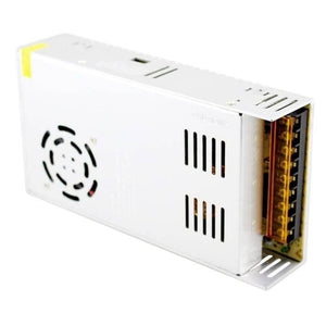 Switching Power Supply SMPS 24V 15A - shown as a white rectangular metal unit with a cooling fan, side ventilation slots, and a terminal block on one end.
