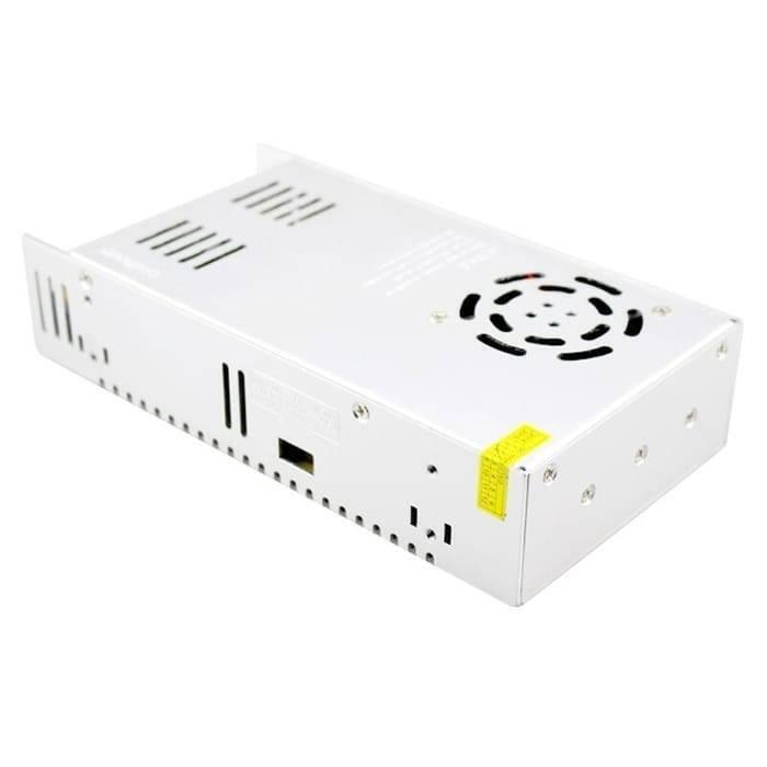 Switching Power Supply SMPS 24V 15A - shown as a silver rectangular metal unit featuring a cooling fan, side ventilation slots, and a small yellow sticker.
