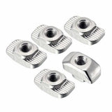 T Nuts | Slot Nuts | Aluminium 20XM5 - a collection of five silver, rectangular metal nuts with threaded holes and ribbed edges on a white background.