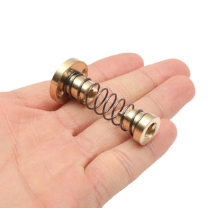 T8 Anti Backlash Spring Loaded Nut For CNC 8mm Threaded Rod Lead Screw - a brass nut assembly with a coiled metal spring held in a person's hand.