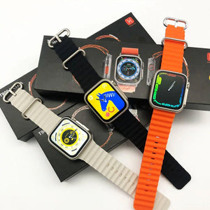 T900 Ultra 2 smart watch with 2.19 big display Vital b - three watches with grey, black, and orange bands and digital displays atop their black packaging boxes.