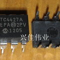 TC4427A Dual High-Speed MOSFET Driver IC - two black 8-pin DIP integrated circuit chips with white text markings on a wooden surface.