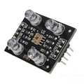 TCS3200 Color Sensor Module - a black circuit board with four LEDs, a central sensor chip, and a row of eight output pins.