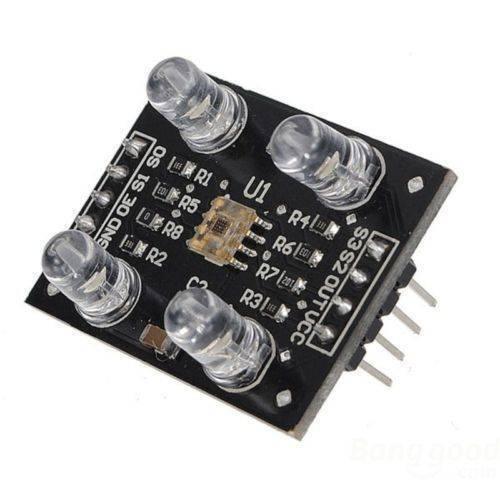 TCS3200 Color Sensor Module - a black circuit board with four LEDs, a central sensor chip, and a row of eight output pins.
