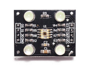 TCS3200 Color Sensor Module - a rectangular black circuit board with a central sensor, four LEDs, and labeled pin headers for GND, OE, S1, S0, S3, S2, OUT, VCC.