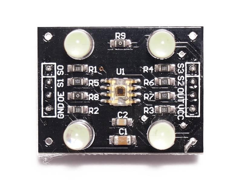 TCS3200 Color Sensor Module - a rectangular black circuit board with a central sensor, four LEDs, and labeled pin headers for GND, OE, S1, S0, S3, S2, OUT, VCC.