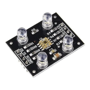 TCS3200 Color Sensor Module - a black rectangular circuit board with four white LEDs, a central sensor chip, and a row of eight connection pins.