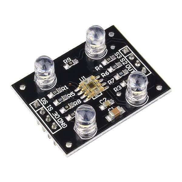 TCS3200 Color Sensor Module - a black rectangular circuit board with four white LEDs, a central sensor chip, and a row of eight connection pins.