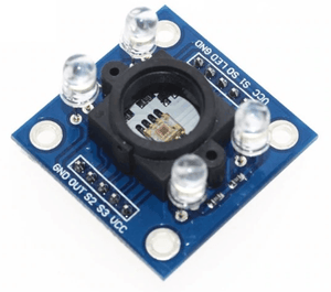 TCS3200 Color Sensor Module With Cap - a blue circuit board with a central sensor, four white LEDs, and two rows of labeled pin headers.