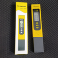 TDS Meter - Water Quality Tester - shown with its yellow and grey handheld unit next to its matching yellow and white retail packaging box.