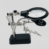 TE 800 Magnifying Glass 5 LED Auxiliary Clip Magnifier 3 In 1 Hand Soldering Solder Iron Stand Holder Station - a black base, a magnifying lens, a 5-LED light, and two adjustable metal alligator clips.