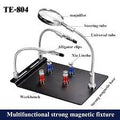 TE-804 Soldering Third Hand Magnetic Universal PCB Motherboard Fixture With Magnifier - a black magnetic workbench with two flexible arms, alligator clips, and a magnifying glass on a universal tube.