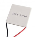 TEC1 12710 Thermoelectric Cooler Peltier Module 12VDC 10A 40x40x3.2mm - a square white ceramic plate with printed text and one black and one red wire extending from the side.