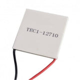TEC1 12710 Thermoelectric Cooler Peltier Module 12VDC 10A 40x40x3.2mm - a square white ceramic plate with printed text and one black and one red wire extending from the side.