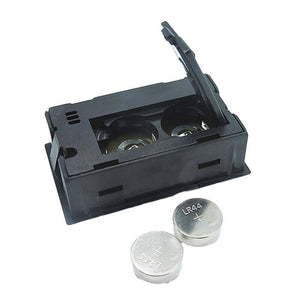 Temperature And Humidity Meter - the black plastic housing with an open battery compartment and two included LR44 button cell batteries.