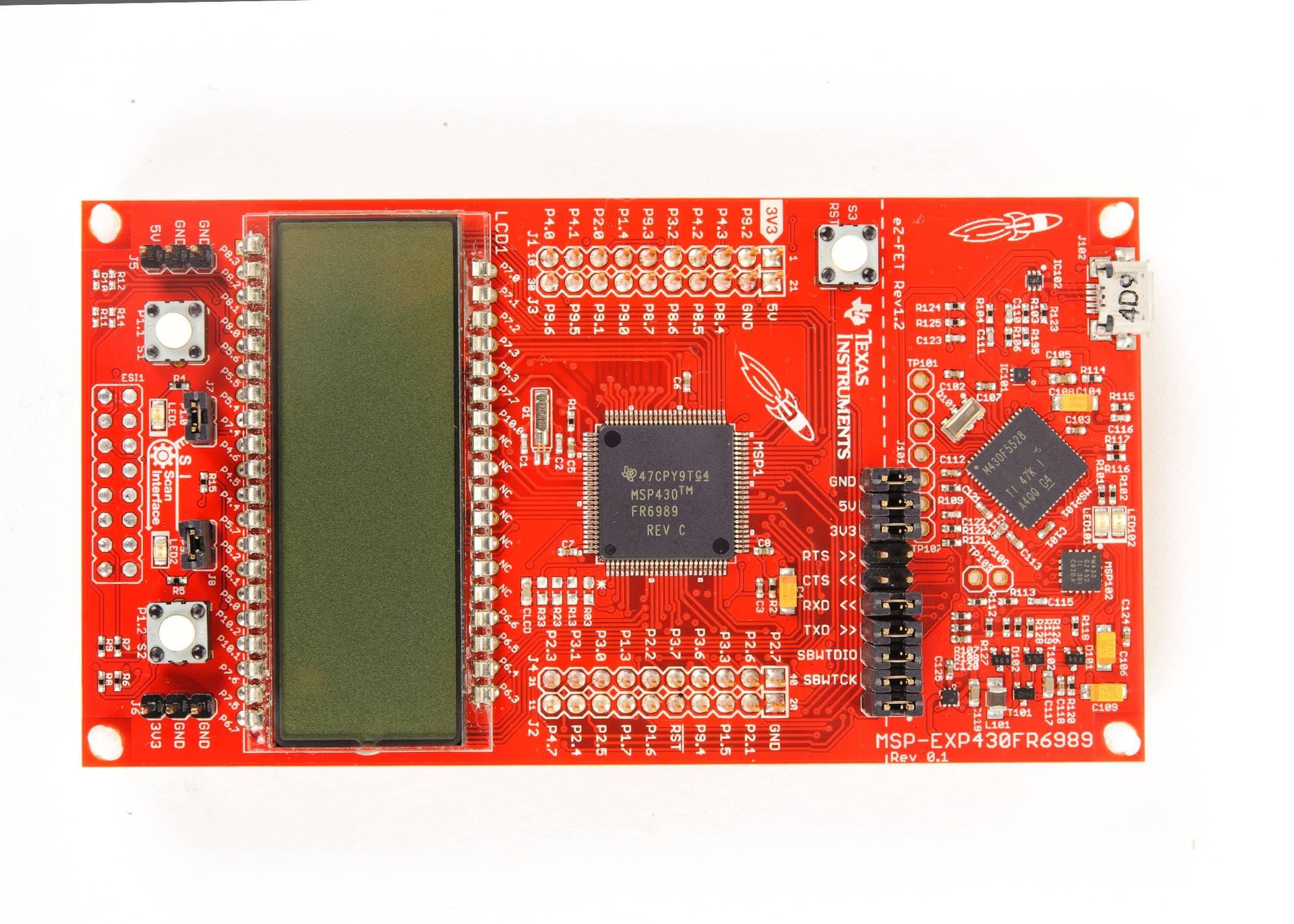Texas Instruments MSP-EXP430FR6989 Dev Kit, Launchpad, MSP430FR6989 MCU, Energytrace - a red rectangular circuit board featuring a central microcontroller, LCD screen, and USB port.