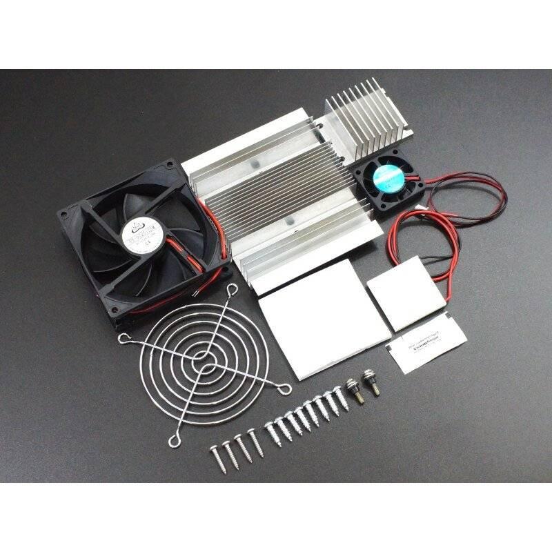 Thermoelectric Peltier TEC1-12706 Cooler Kit - shown as a disassembled set including two silver aluminum heatsinks, two cooling fans, a fan guard, and screws.