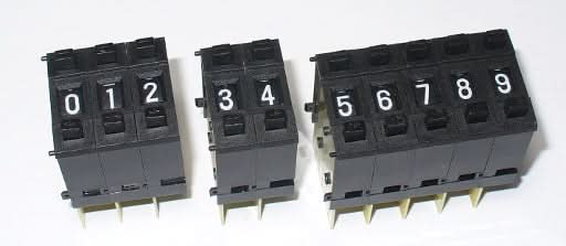 ThumbWheel BCD Switch - shown as three separate black modular units displaying the digits 0 through 9 on individual push-button wheels.