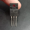 TK17A80W N-Channel Power MOSFET - a black three-pin electronic component held by fingers, showing the model number printed on its face.