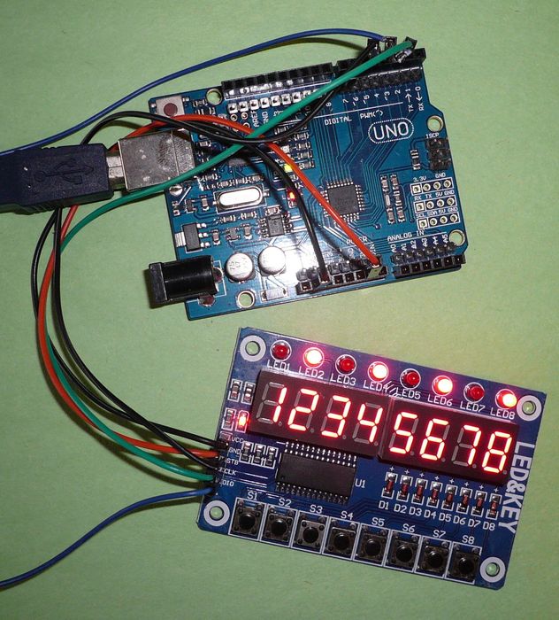 TM1638 8 Digit 7 Segment Display With LED’s And Switches - connected to a blue Arduino Uno, showing the digits 12345678 and illuminated red LEDs.