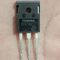 Toshiba K065N65Z Power MOSFET - a black, rectangular three-pin electronic component held in a palm, showing the model number printed on its front face.