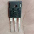 Toshiba K62N60W5 Power MOSFET - a black, rectangular electronic component with three metal pins, held against a person's palm.