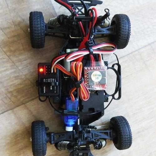 Towerpro SG90 Sg 90 180 Degree Servo Motor - shown installed in the central chassis of a small remote-controlled car with visible wiring and electronic components.