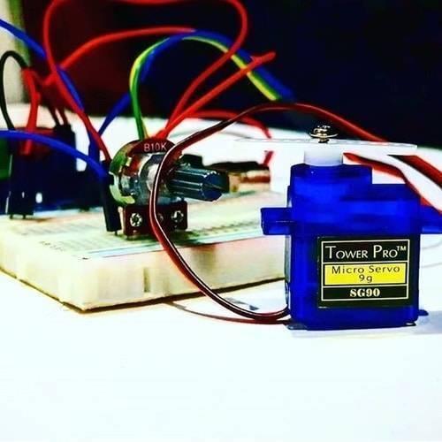 Towerpro SG90 Sg 90 180 Degree Servo Motor - shown in blue with a white plastic horn, wired to a B10K potentiometer on a breadboard.