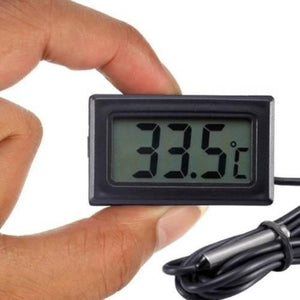 TPM10 Digital Thermometer Temperature Sensor Tester Meter Fy-10 With Metal Sensor - held by a hand, showing a black rectangular display reading 33.5°C with a connected metal sensor probe and black cable.