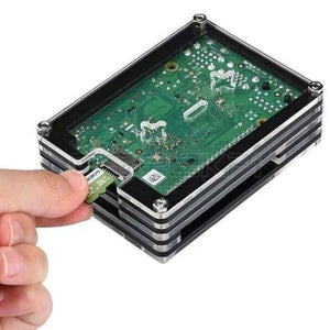 Transparent Acrylic Case For Raspberry Pi 4b With Cooling Fan And Heat Sink Clear And Black Case - a hand inserting a microSD card into the port of a black and clear layered case housing a circuit board.