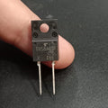 TRS8A65F 650V 8A Schottky Barrier Diode - a close-up of the black rectangular electronic component with two metal pins held between fingers.