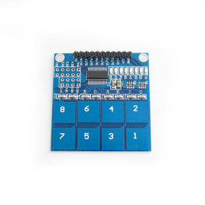 TTP226 8 Channel Digital Capacitive Touch Sensor Module - a blue rectangular circuit board with eight numbered touch pads and a top header connector.