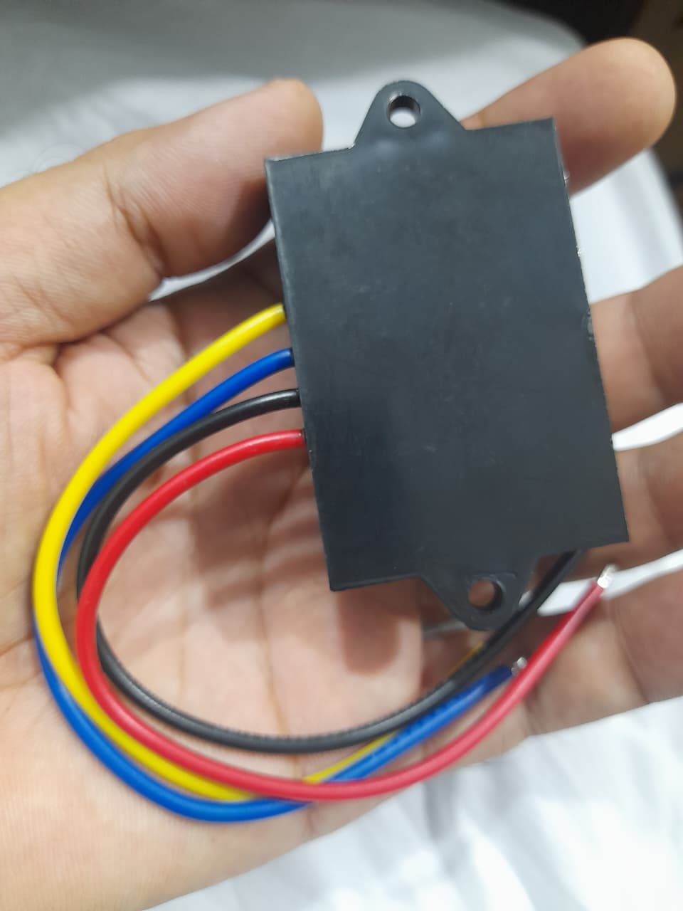 UENPO 12V 5A DC Isolated Power Supply 75~150V to 5V Voltage Reduction Module - a black rectangular casing with four coloured wires extending from one side.