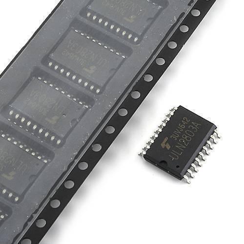 ULN2803A SMD Hi-voltage Current Darlington Transistor Array - shown as a single black surface-mount component next to a plastic tape reel containing multiple identical units.
