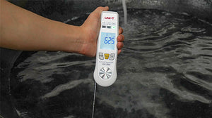 UNI-T A63 2-in-1 Food Thermometer – Infrared + Fold-Out Probe, -40 to 300℃, Laser Targeting, Kitchen / BBQ Cooking Thermometer - a white handheld device with a fold-out probe, held over water with a digital display showing 625 degrees Celsius.
