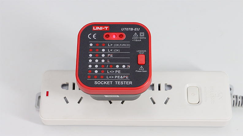 UNI-T UT07A-EU Socket Tester for EU Schuko Outlets – Mains Power Socket Wiring Fault Checker with Earth (PE), Live, Neutral & Reverse Polarity Detection, 230V 50/60Hz - UNI-T UT07B-EU socket tester plugged into a white power strip, showing red LED indicator lights on its face and a red leakage test button on the side.