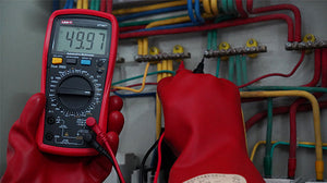 UNI-T UT107+ True RMS Automotive Multimeter – 6000 Count, RPM, Dwell Angle, Pulse Width, Battery Test, Temperature, 1000V AC/DC, VFC, CAT III 600V - held by gloved hands, showing a red casing, rotary dial, ports, and a digital display reading 49.97.