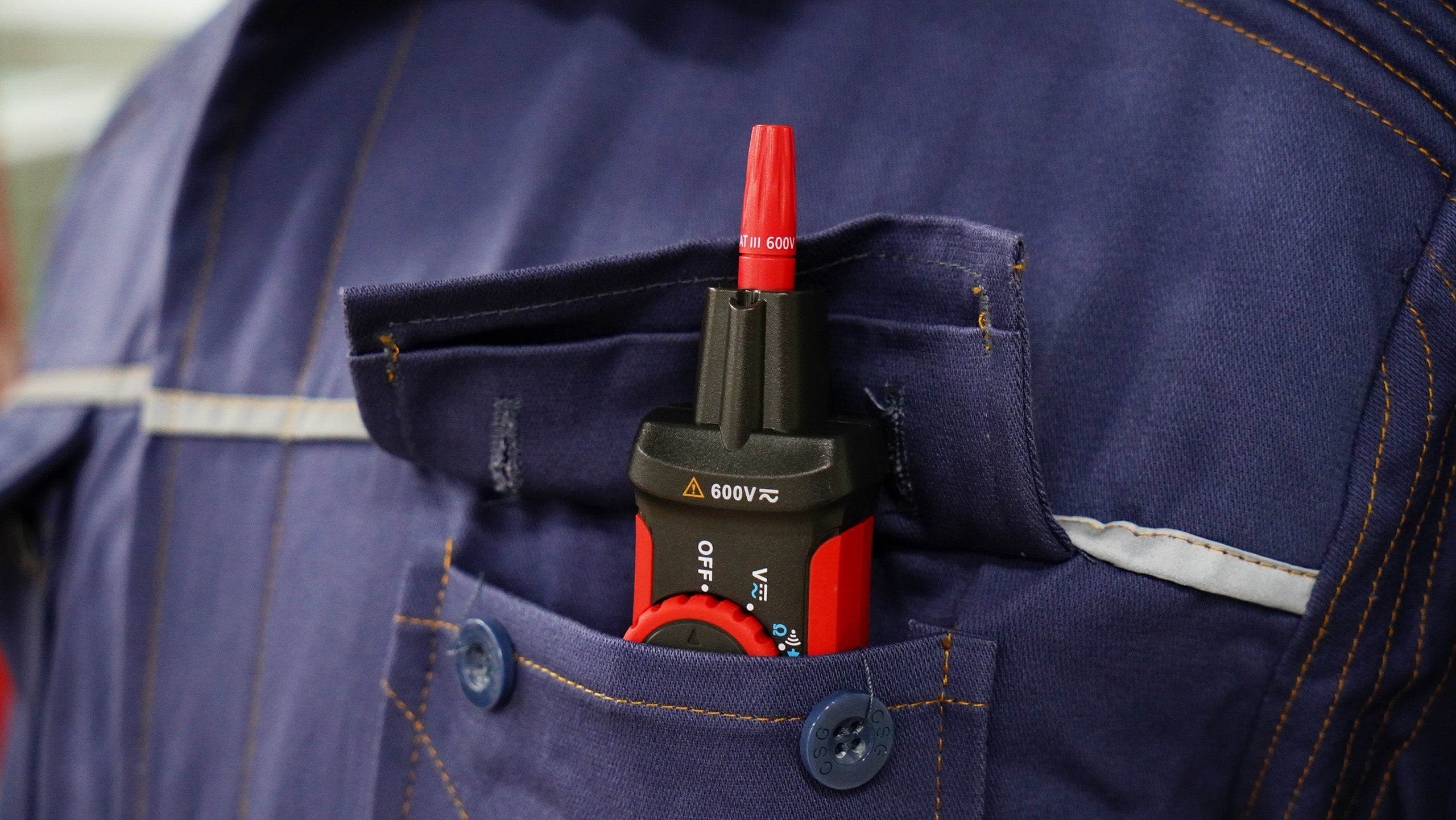 UNI-T UT118C True RMS Pen Type Digital Multimeter – AC/DC 600V, Resistance, Capacitance, NCV, Gold-Plated Tips, CAT III 600V / CAT IV 300V - in a red and black casing with a red tip, shown tucked into the pocket of a blue work shirt.