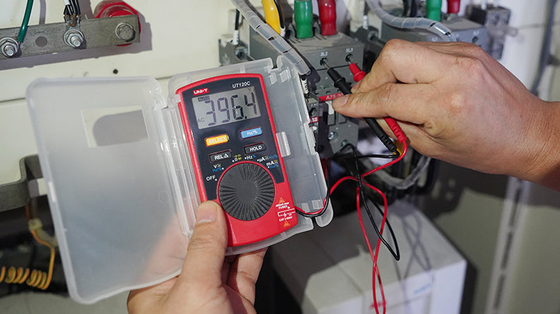UNI-T UT120C Pocket Size Digital Multimeter – 4000 Count, Auto-Range, AC/DC Voltage, Capacitance, Resistance, Frequency, Diode, EBTN Display, 2m Drop-Proof - in a red case with a protective cover, showing a 396.4 AC voltage reading while being used to test electrical terminals.