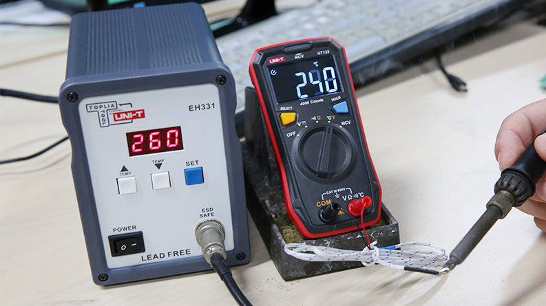 UNI-T UT123 Pocket Residential Digital Multimeter – EBTN Display, AC/DC Voltage, Resistance, Temperature, NCV, Diode & Continuity, One-Hand Design - with a black and red body showing 290 degrees Celsius on its EBTN display while measuring a soldering iron tip.