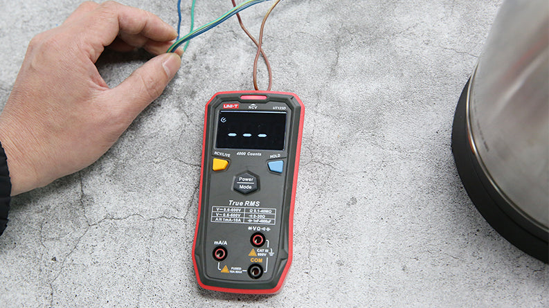 UNI-T UT123D Smart Digital Multimeter – Auto-Identify, EBTN Display, AC/DC Voltage, Capacitance, Resistance, NCV, Diode & Continuity, One-Button Operation - with a black and red casing, a blank EBTN display, and two test leads connected to the bottom ports.