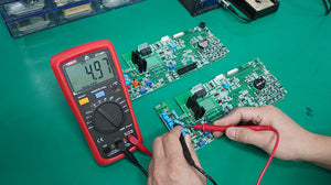 UNI-T UT136B+ Auto-Range Digital Multimeter – 4000 Count, AC/DC 1000V, 10A, Capacitance 40mF, Frequency, Temperature, hFE, Diode, 2m Drop-Proof - with a red casing, rotary dial, and LCD screen showing 4.97 kΩ, being used to test a green circuit board.